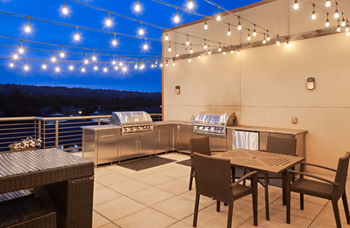 A patio with a table and chairs is set up for an outdoor meal.